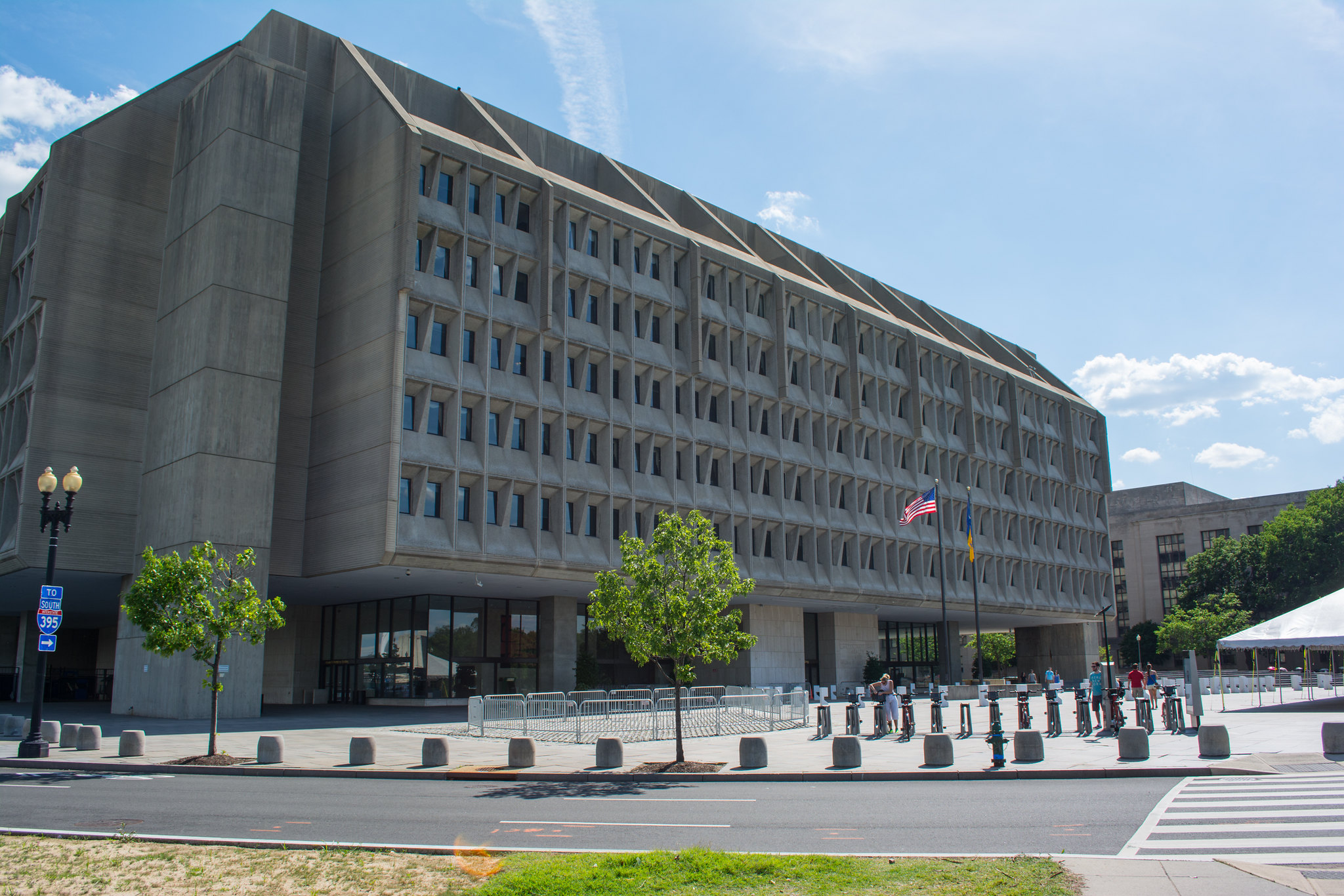 HHS building with rectangular windows and American flag in front.