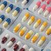 Assorted packs of colorful capsules and tablets.