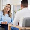man and woman sitting in therapy