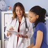 Doctor showing a patient information on a tablet in a medical office.
