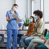 nurse explaining something to patient in clinic 