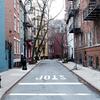 Street between two blocks of houses 