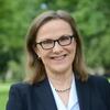 White woman wearing a black blazer outside 